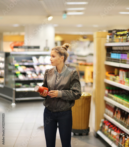 Woman choosing a dairy products at supermarket 