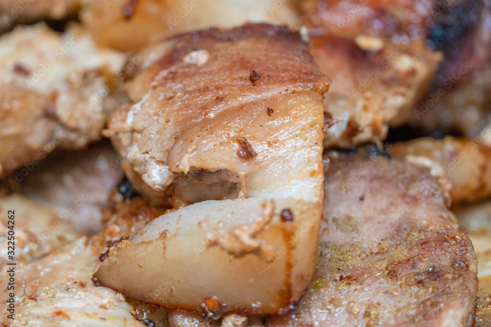 Fried pieces of meat are fried in a pan close up Fried pieces of meat are fried in a pan close up