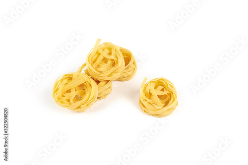 nest of tagliatelle pasta isolated on white background.