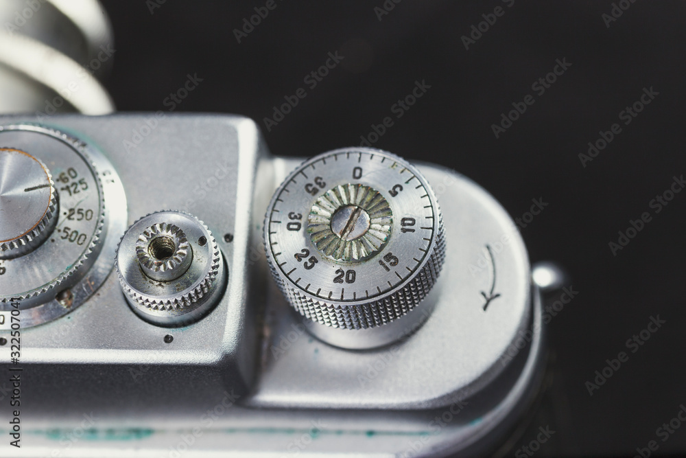Detail of an old camera - adjuster, closeup. Retro camera in scratches and dust from a private collection.