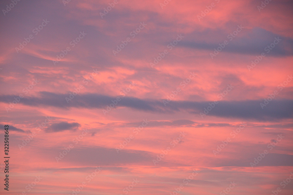 Dreamy evening sky in pastel tones with fluffy pink clouds at sunset Dreamy evening sky in pastel tones with fluffy pink clouds at sunset