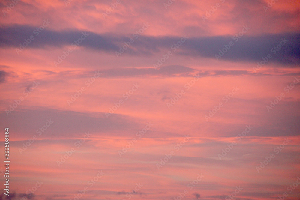 Dreamy evening sky  in pastel tones with fluffy pink clouds at sunset