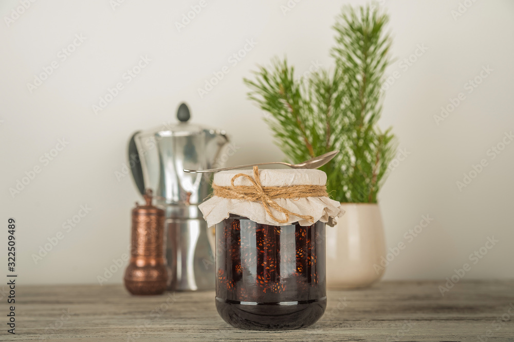 Natural organic jam from pine cones in a jar close-up. Organic jam for health and copy space. Natural organic jam from pine cones in a jar close-up. Organic jam for health and copy space.