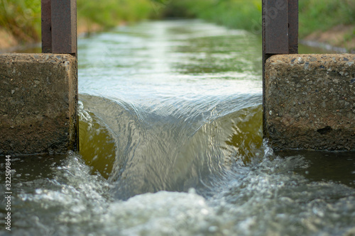 The water flows through the floodgates in the irrigation canals.