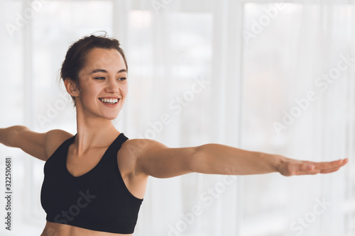 Woman exercising yoga in warrior pose in modern studio Free Download Woman exercising yoga in warrior pose in modern studio - GFXLoad