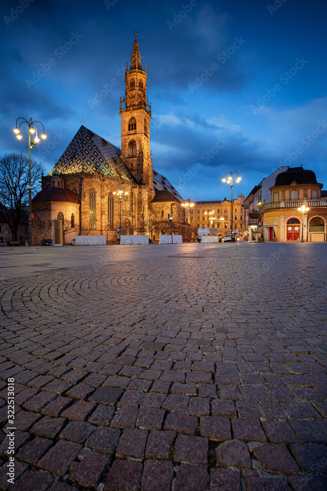 Bolzano, Italy. Cityscape image of historical city of Bolzano, Trentino, Italy with Bolzano Cathedral and the Walther Square during twilight blue hour.