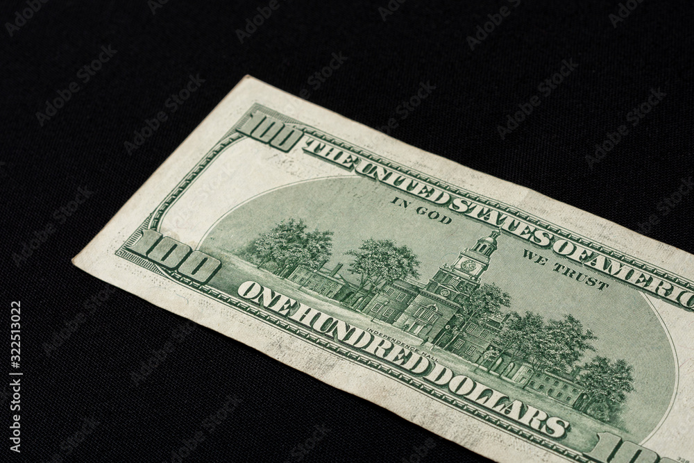 Rear side of old one hundred dollar american currency on black background. Rear side of old one hundred dollar american currency on black background.