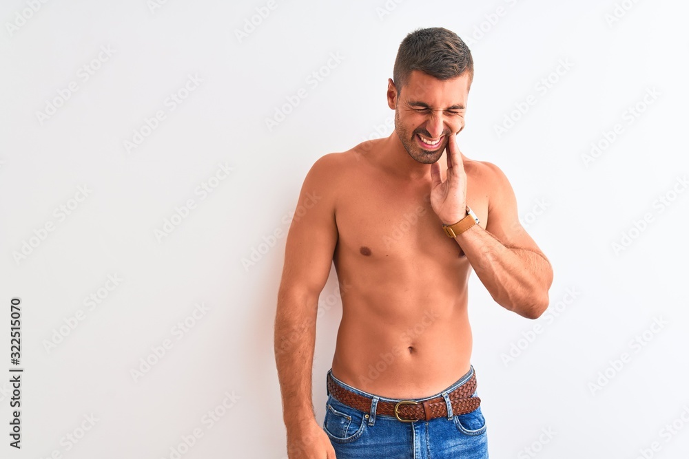 Young handsome shirtless man showing muscular body over isolated background touching mouth with hand with painful expression because of toothache or dental illness on teeth. Dentist concept.