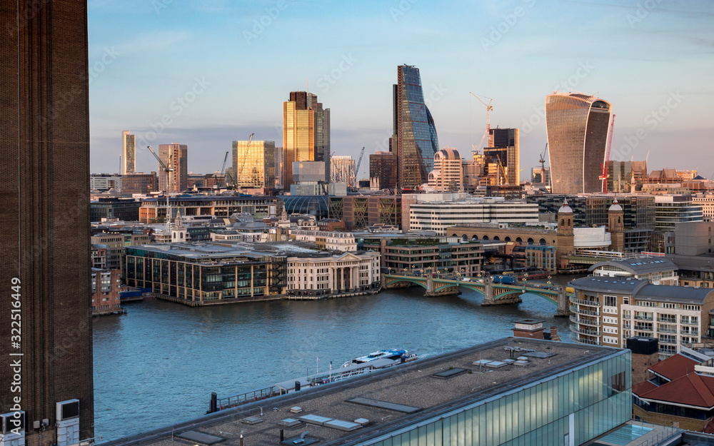 City of London. Landmark skyscrapers in the financial district of the UK capital with the River Thames and Tate Modern in the foreground.