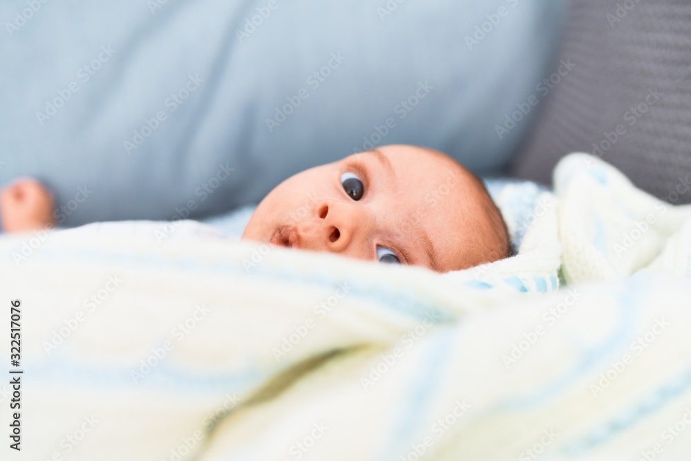 Adorable baby lying down on the sofa at home. Newborn relaxing and resting comfortable Adorable baby lying down on the sofa at home. Newborn relaxing and resting comfortable