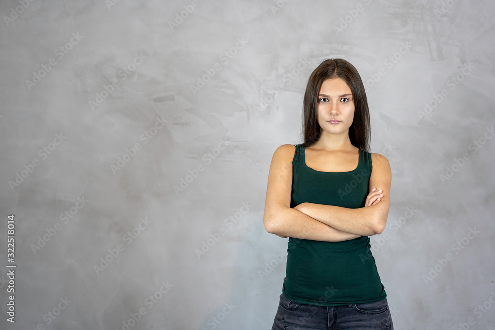 Young pretty woman with angry disappointed face cross hands on grey background. copy space Young pretty woman with angry disappointed face cross hands on grey background. copy space