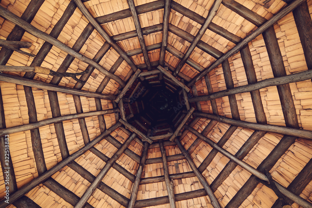 Interior roof beams in wooden gazebo. Architectural design and framing of a gazebo