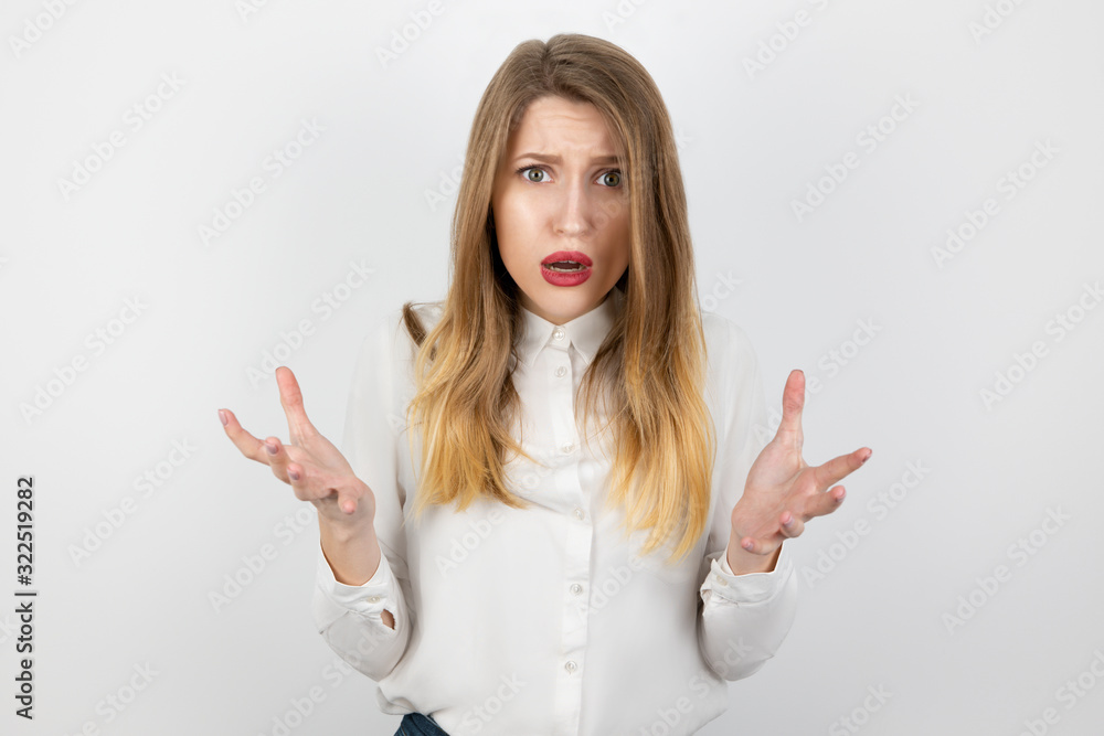 young beatuiful blond angry woman looks desperate standing on isolated white background, splash of emotions young beatuiful blond angry woman looks desperate standing on isolated white background, splash of emotions