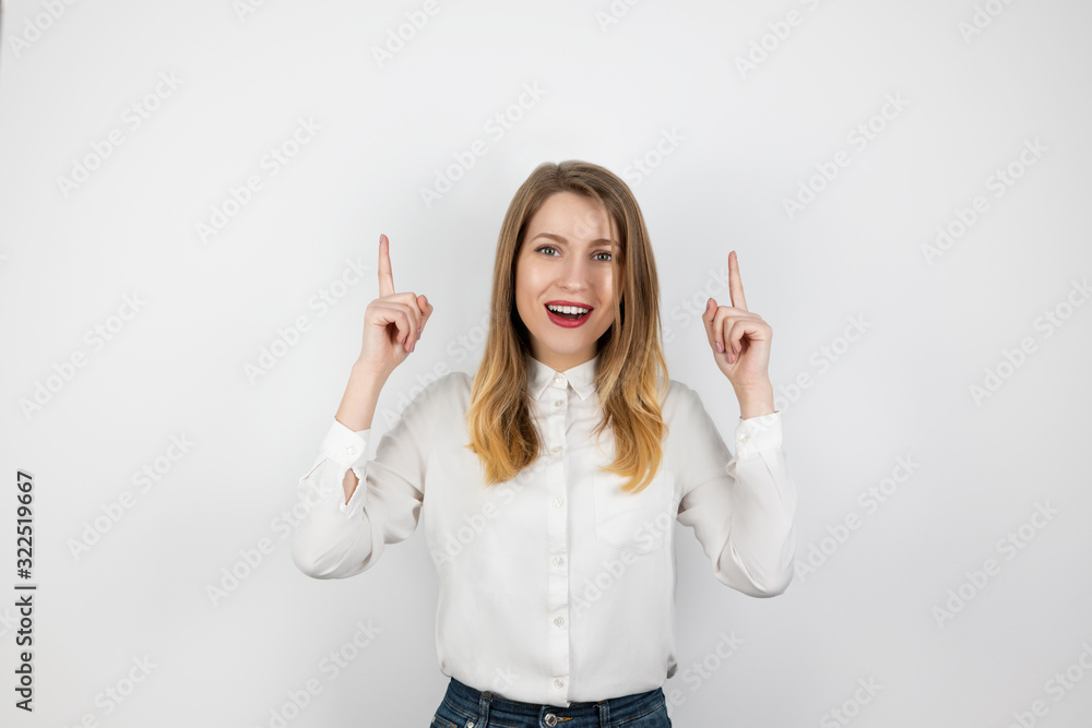 young blond woman showing up direction with her both finger standing on isolated white background, body language concept young blond woman showing up direction with her both finger standing on isolated white background, body language concept
