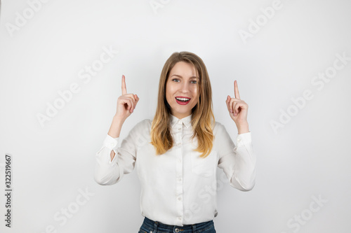 Wallpaper Mural young blond woman showing up direction with her both finger standing on isolated white background, body language concept Torontodigital.ca