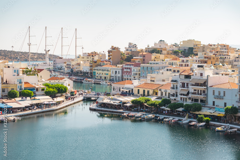 Agios Nikolaos, Crete, Greece. 2019. View of Lake Voulismeni on the northwest side of Mirabello Bay, as well as the harbor and city with fishing boats and restaurants