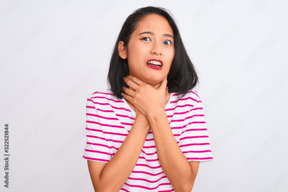 Young chinese woman wearing striped t-shirt standing over isolated white background shouting and suffocate because painful strangle. Health problem. Asphyxiate and suicide concept. Young chinese woman wearing striped t-shirt standing over isolated white background shouting and suffocate because painful strangle. Health problem. Asphyxiate and suicide concept.