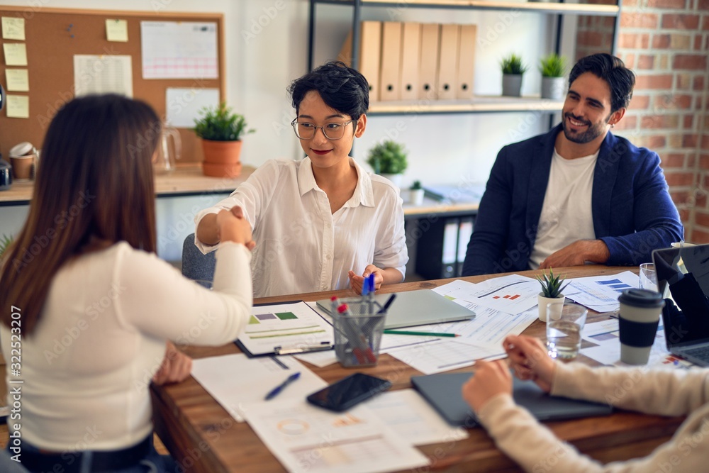 Group of business workers smiling happy and confident. Working together with smile on face shaking hands at the office