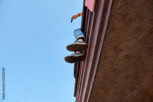 Feet of a young man sitting high