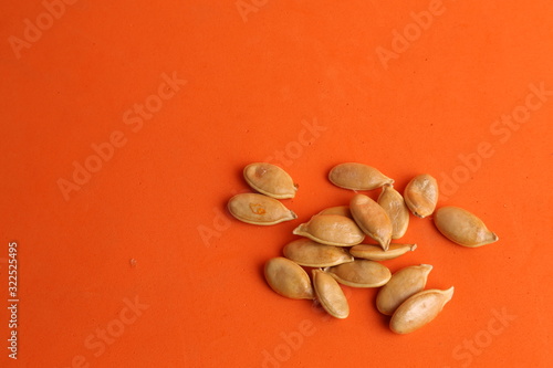 pumpkin seeds on color background