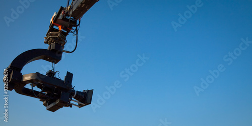 Image of a jib camera or camera crane with sky background 