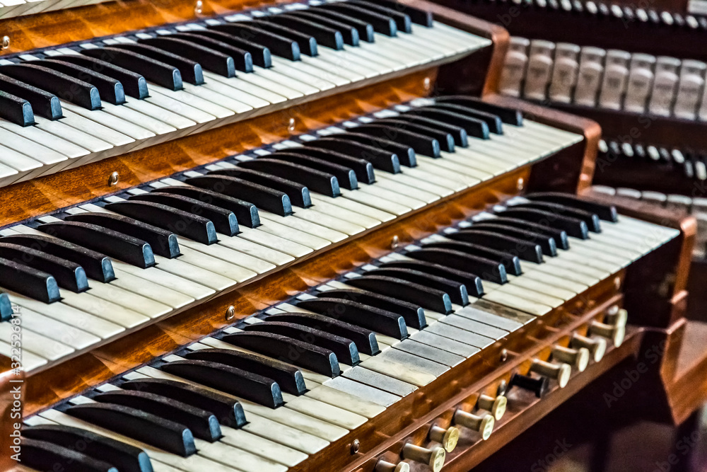 Close up of ancient pipe organ keyboards in european cathedral Close up of ancient pipe organ keyboards in european cathedral