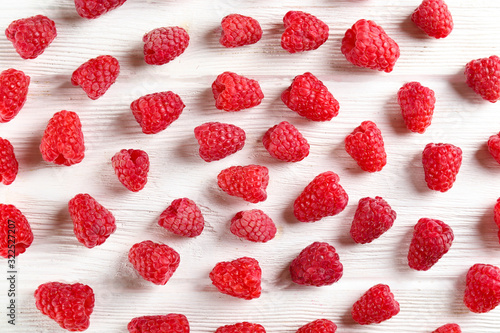 Bunch of fresh organic raspberry berries in seamless ornament pattern, white background. Clean eating concept. Healthy nutritious vegan snack, tasty raw diet. Close up, copy space, top view, flat lay.