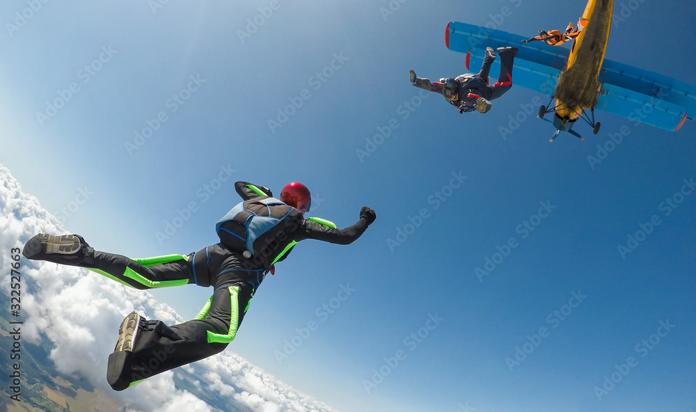 Skydivers jump out of the plane - obrazy, fototapety, plakaty 