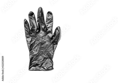 thin black latex glove on white background. Used disposable dirty rubber gloves. Protective subject