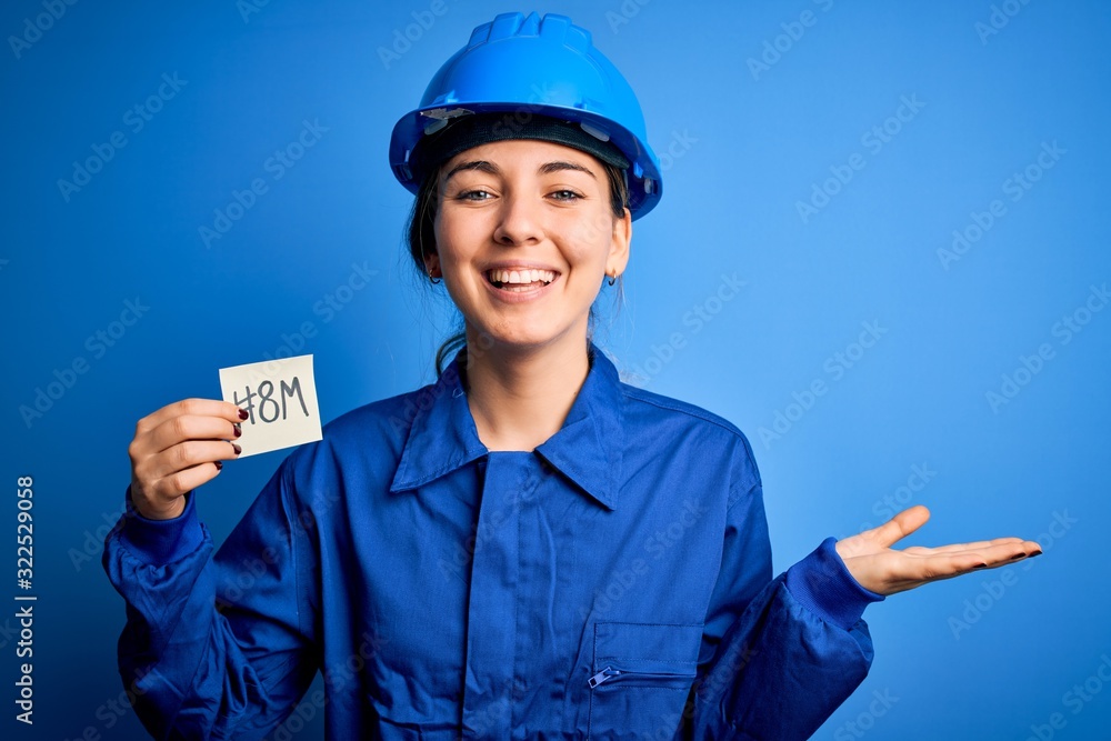 Beautiful worker woman wearing hardhat and uniform celebrating 8th march womens day very happy and excited, winner expression celebrating victory screaming with big smile and raised hands Beautiful worker woman wearing hardhat and uniform celebrating 8th march womens day very happy and excited, winner expression celebrating victory screaming with big smile and raised hands