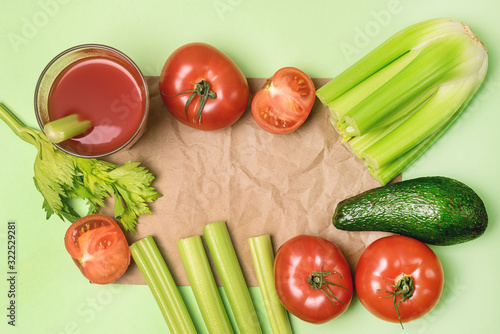 Background or Flat Lay with Glass of Tasty and Healthy Tomatoes and Celery Juice Raw Tomatoes Celery and Avocado on Green Background Top View Flat Lay Copy Space