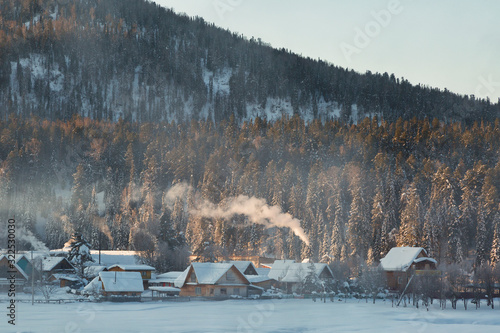 Wallpaper Mural Winter landscape with a village on a background of a mountain at sunrise, Altai, Russia Torontodigital.ca