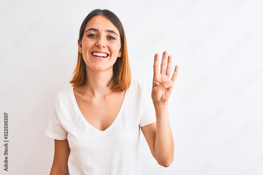 Beautiful redhead woman wearing casual white t-shirt over isolated background showing and pointing up with fingers number four while smiling confident and happy. Beautiful redhead woman wearing casual white t-shirt over isolated background showing and pointing up with fingers number four while smiling confident and happy.