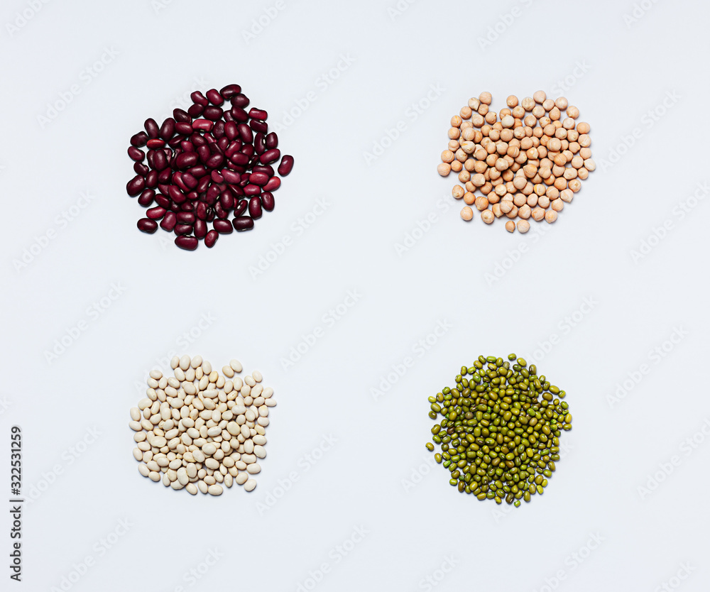 Various legumes: chickpeas, lentils, mung, red and white bean on a gray background. Copy space. Flat lay. Various legumes: chickpeas, lentils, mung, red and white bean on a gray background. Copy space. Flat lay.