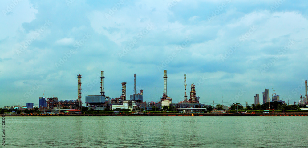 Oil refinery environmentally friendly, with sky and clouds, river