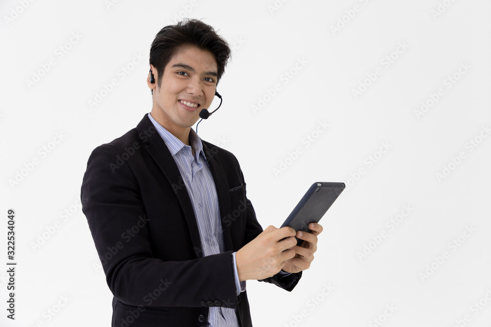 Young call center staff talking and provide services to customers via headphones and microphone cable with tablet. Professionals with speech, service mind and information recording skills. Young call center staff talking and provide services to customers via headphones and microphone cable with tablet. Professionals with speech, service mind and information recording skills.
