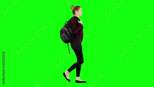 Happy Girl Walking With a Backpack in Casual Hoodie and Black Jeans Green Screen
