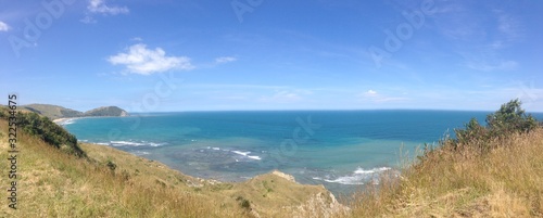 Panorama view of the blue Ocean from top of a hill with dry vegetation