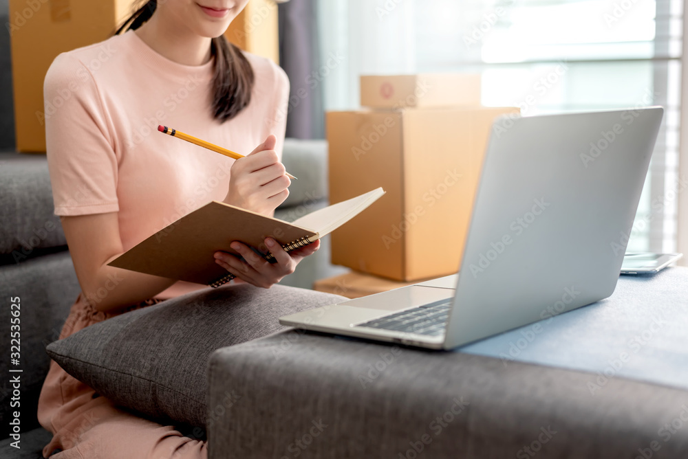 Happy beautiful girl who works at home About Online Business, Prepare goods to customers. Happy beautiful girl who works at home About Online Business, Prepare goods to customers.