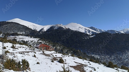 Isolated house in snowed mountains of Falakro in winter photo