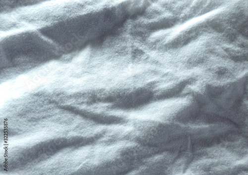 A textile set of crumpled white fabric with pleats and waves.