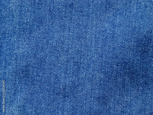 Denim close-up as an abstract textile background for the design. Blue jeans.