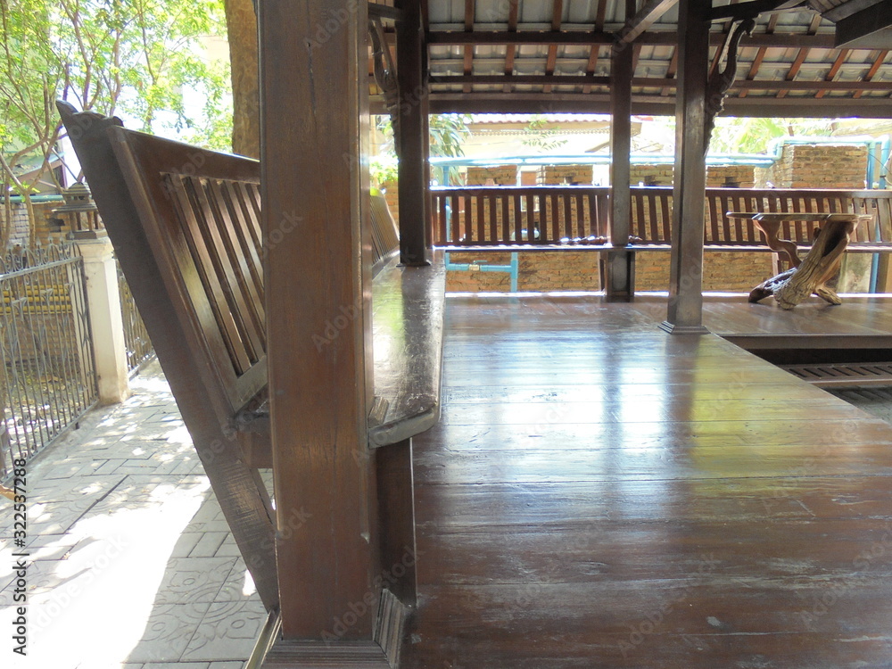 Fototapeta premium A wooden table and chair in a temple pavilion