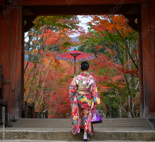 Photography woman holding retro umbrella in old fashion style traditional kimono, swalks alo