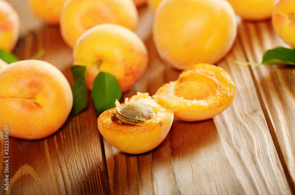Ripe organic apricots on wooden table closeup