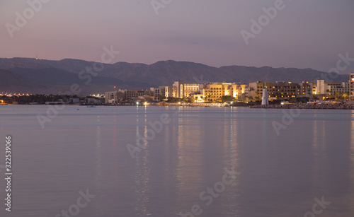 Sunset in Aqaba city, view of Eilat city in Israel. Aqaba city, Jordan