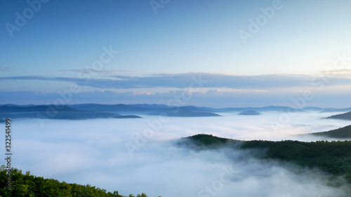 Beautiful cloud sea among mountains in the morning  white fog on the top of mountains © Wheat field