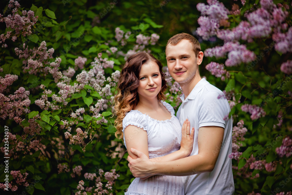 happy couple in a blooming lilac garden