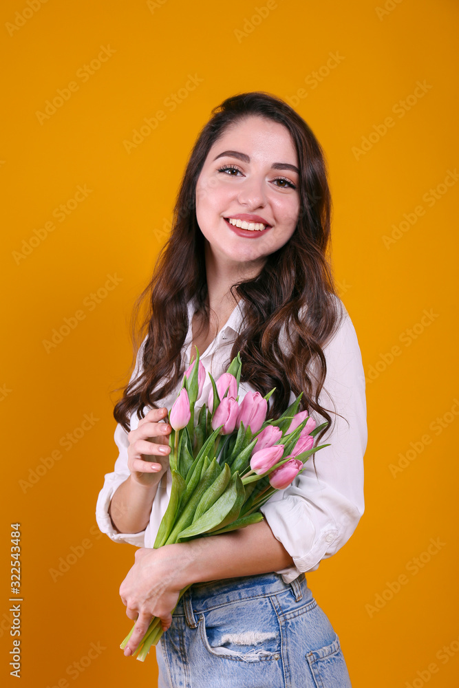 Beautiful female holding bouquet of springtime flowers for international women's day holiday. Beautiful female holding bouquet of springtime flowers for international women's day holiday.