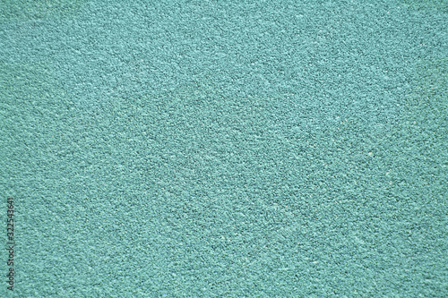 Turquoise horizontal wall covered with plaster texture.